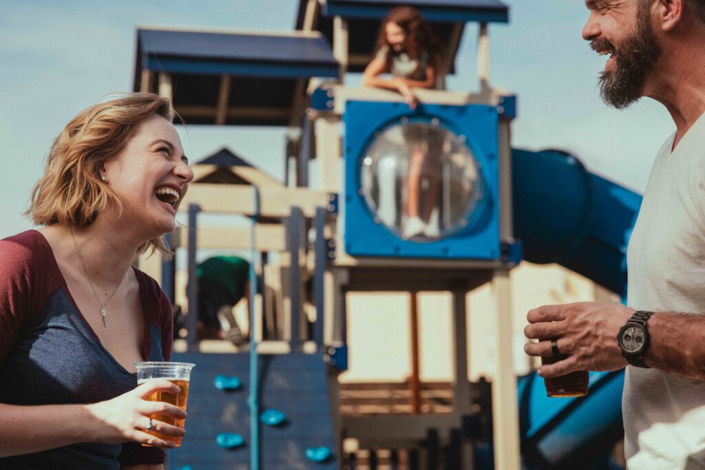 Family hanging out on the playground at Wild Acre