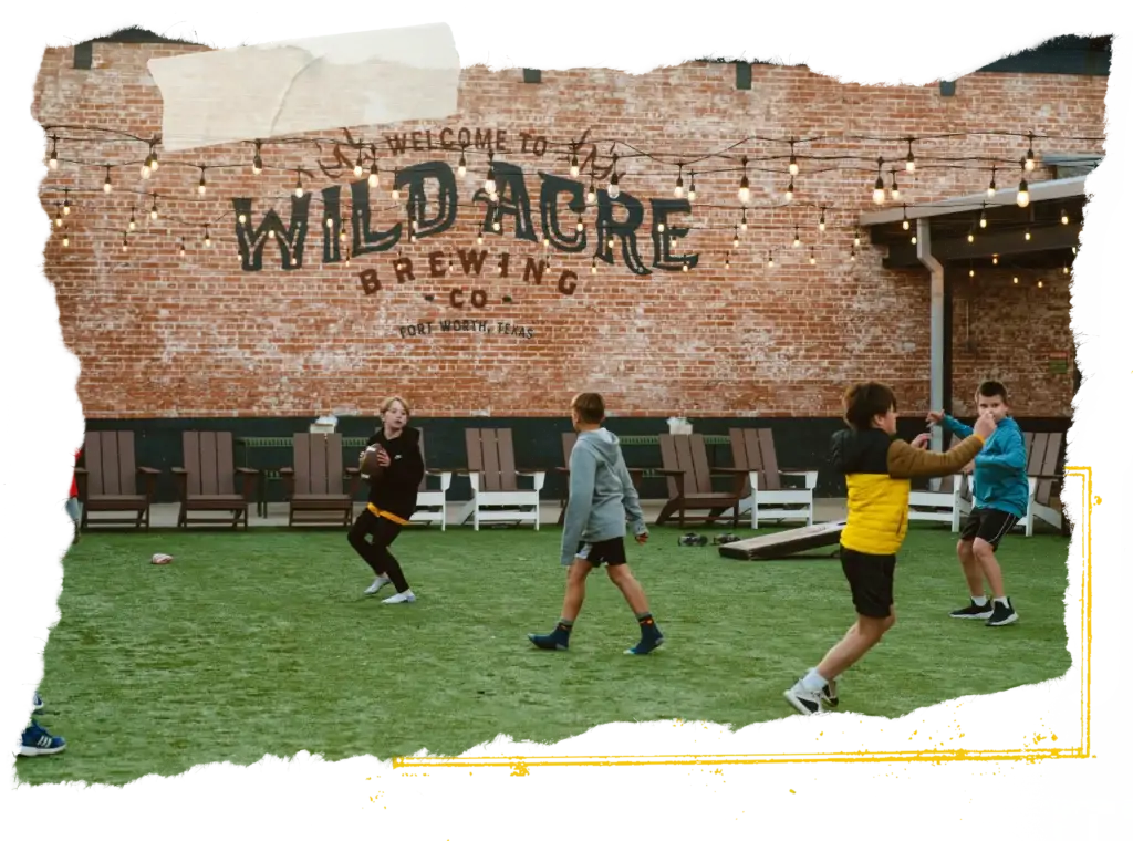 kids tossing the football on the turf yard
